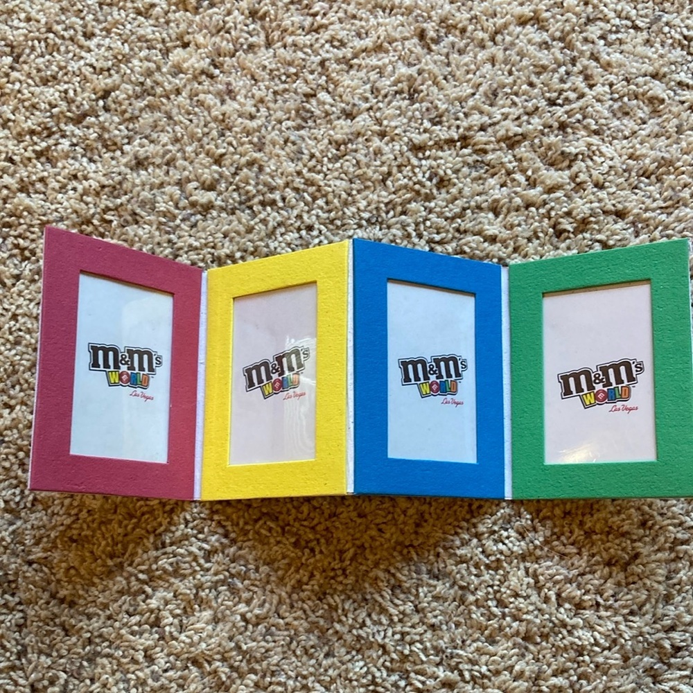 M&M'S World Logo Graphic with Red, Yellow, Blue, Green, Orange, Brown Accents